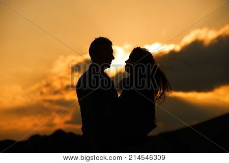 Kissing couple silhouette in the sunset sky. Allways together forever and Love concept. Feeling in love
