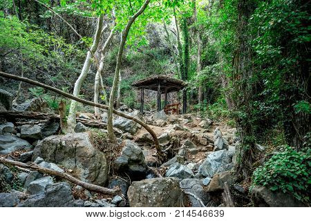 A small shed with a bench in the middle of a hiking trek to Caledonia waterfall near Platres Cyprus