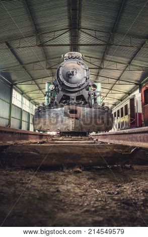 Front View of an Old Steam Locomotive Standing in the Depo