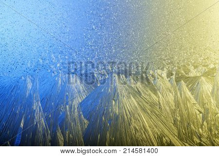 Frozen glass. Fabulous winter. Frosty patterns on the window. A Christmas story. The Christmas cheer.