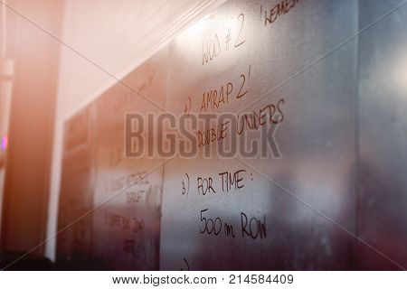Metal Board With Written Crossfit Exercises