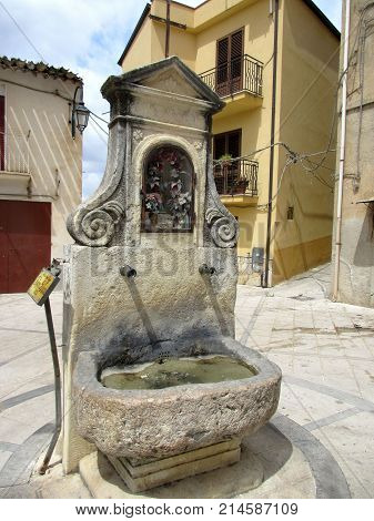 an old foutain on a village square in spain