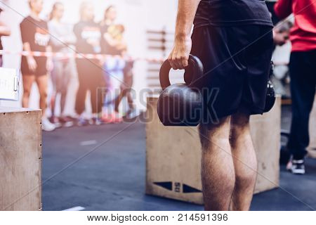 Man Pulling Kettlebells Weights In The Functional Fitness Gym