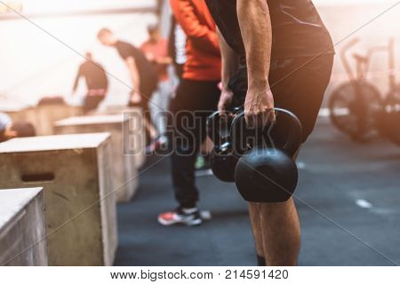 Man Pulling Kettlebells Weights In The Functional Fitness Gym