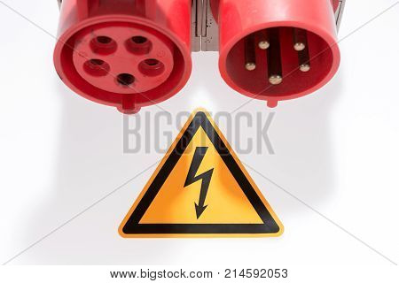 Red and white three-phase plug and socket with warning sign isolated