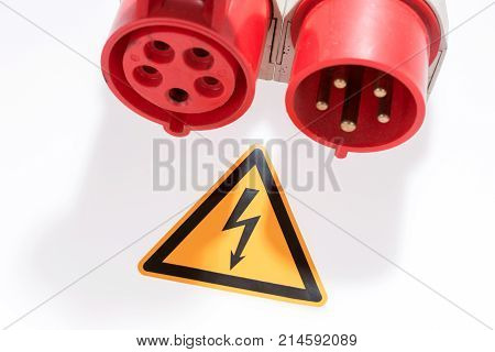 Red and white three-phase plug and socket with warning sign isolated