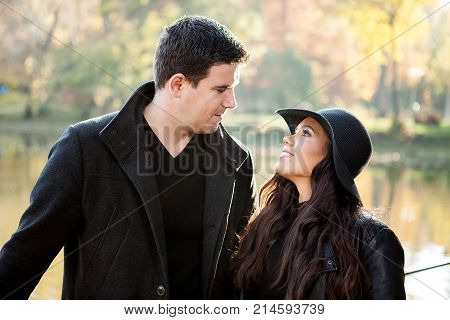 Beautiful gourgeous couple walking in an autumn park