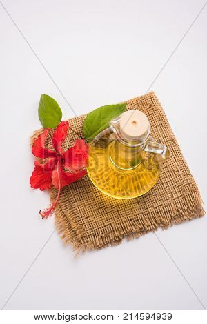 Jaswand or Hibiscus oil and bath soap/shampoo with flower and Reetha fruit and white towel