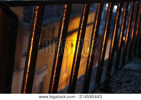 Behind the bar. Point of view behind a railing at night