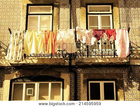 Photo representing life lived in lisbon cloths in the sun