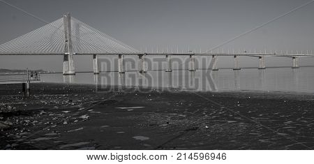 Panoramic photo of Vasco da Gama bridge in Lisbon on a sunny day.
