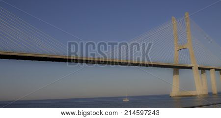 Panoramic photo of Vasco da Gama bridge in Lisbon on a sunny day.