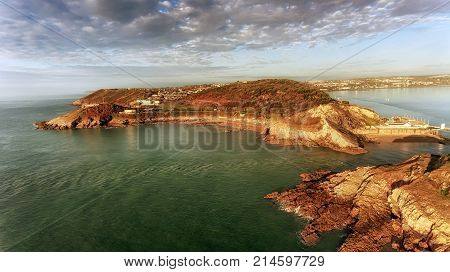 Aerial view of Bracelet Bay in Swansea, South Wales, UK, showing the middle island at Mumbles pier and lighthouse