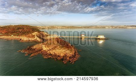 A calm morning at Mumbles Pier, an aerial view showing the new lifeboat station and the middle island, Swansea, South Wales, UK
