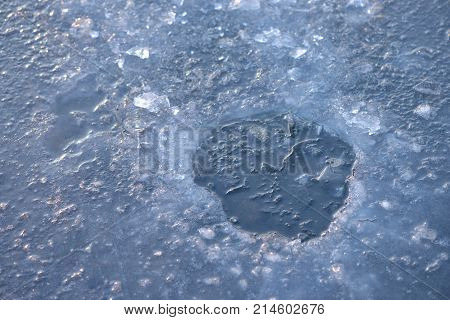 Ice hole ready hor ice fishing on frozen lake sunrise light