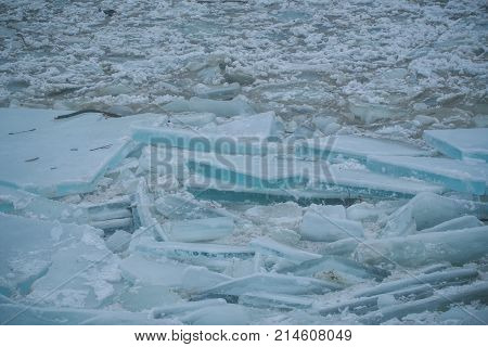 Background with cracked ice frozen texture. Texture of spring melt snow on water. Frost crystal icy Christmas backdrop. Christmas frozen glacier texture. Winter ice block background new year.