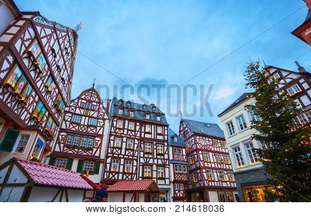 Traditional half-timbered houses  decorated for Christmas on  Marketplace  at dusk, Bernkastel-Kues, Rhineland-Palatinate, Germany.