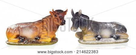 Figures of a ox and a mule for the Nativity Potal isolated on a white background