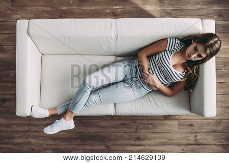 Top view of young woman is lying on sofa during the psychotherapy session. Girl at a psychologist's reception.
