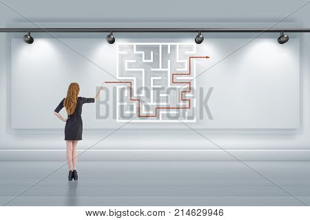 Businesswoman is looking for ways to escape from maze labyrinth