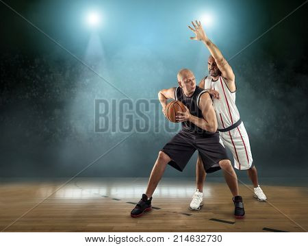 Caucassian Basketball Players in dynamic action with ball in a professional sport game on the arena.