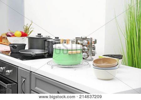 Stewpan and bowls on table in kitchen