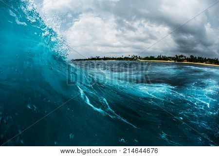 Ocean wave breaking on reef shore. Surfing point break spot named Lazy Lefts, Midigama, Sri Lanka