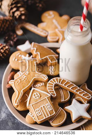 Milk and cookies. Gingerbread cookies on a gray background. Christmas cookies. Ginger men
