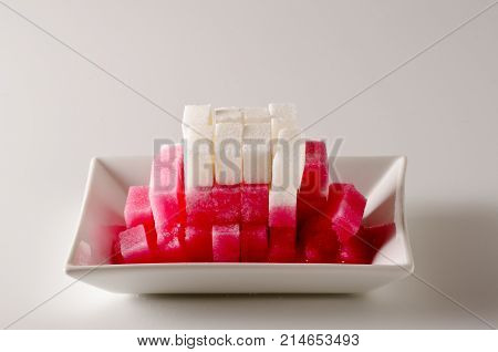 Physics. Capillary action. Dyed water is going up sugar cube tower. 