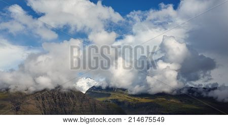 Travel to Iceland. bright sunny mountain landscape. Vatna volcano covered with snow and ice on tne background.