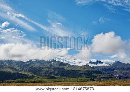 Travel to Iceland. bright sunny mountain landscape. Vatna volcano covered with snow and ice on tne background.