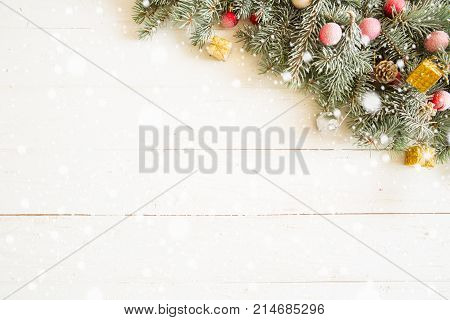 Fir Branch With Christmas Decorations On The White Wooden Table Or Plank Background