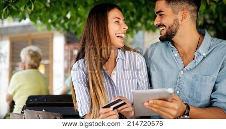 Happy young couple doing shopping on internet