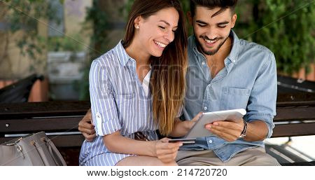 Happy young couple doing shopping on internet