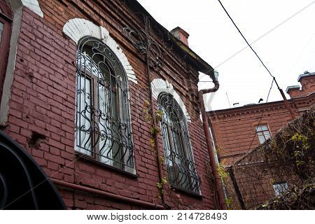 Windows with lattice. Old red brick mansion. Voronezh.