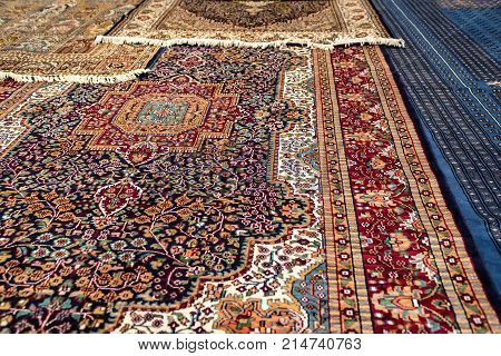 Variety of colorful Persian and Indian carpets on oriental bazaar
