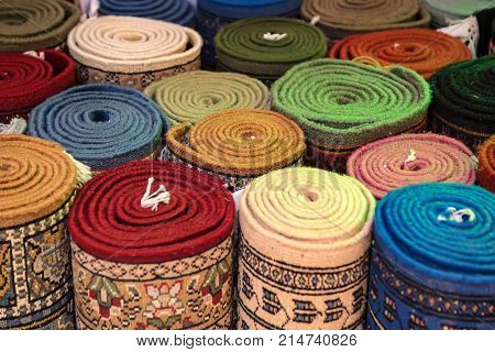Variety of colorful Persian and Indian carpets on oriental bazaar