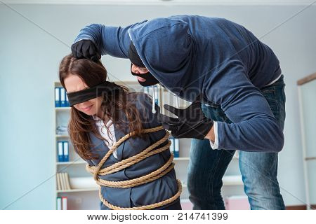 Criminal taking businesswoman as hostage in office