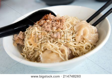 Close up of Sarawak wanton noodle with dumplings and minced meat