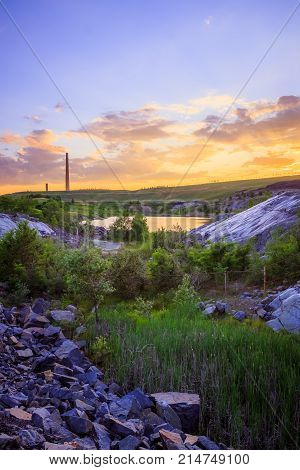 View of a smelter stack of a nickel plant showing the emission on the air with sunset sky as as background