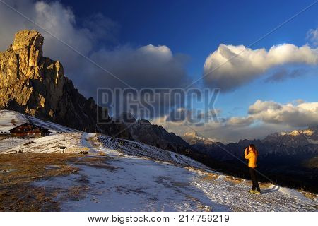 Young girl taking photos in the Dolomites, Italy, Europe