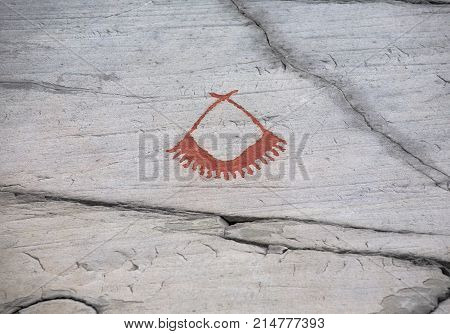 prehistoric rock carving petroglyphs on stone surface closeup