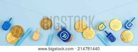 Blue Background With Multicolor Dreidels, Menora Candles And Chocolate Coins. Hanukkah And Judaic Ho
