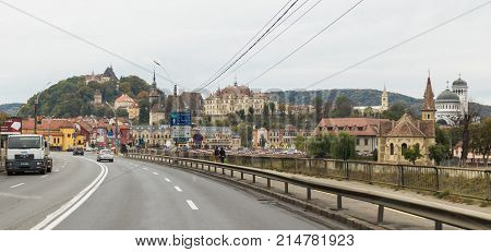 Sighisoara Romania October 08 2017 : View of the old town of Sighisoara from the central highway passing through the city. Sighisoara Romania