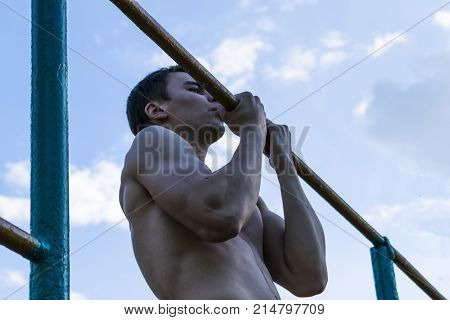 The young man pulled on the bar