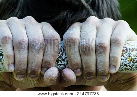 young man holding hands on the horizontal bar