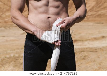 A young man goes in for sports on the sand