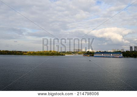 A blue floating house on the banks of the Dnieper River. Landscape.