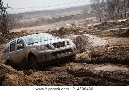 Horizontal outdoors shot of offroadster driving in the mud.