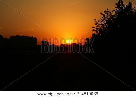 Sunrise at city of Lyubertsy Russian Federation orange round sun and the silhouette of the city